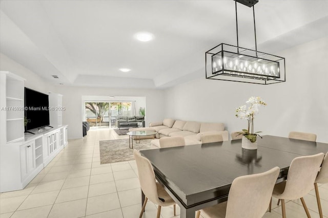 dining room featuring a tray ceiling, recessed lighting, and light tile patterned floors