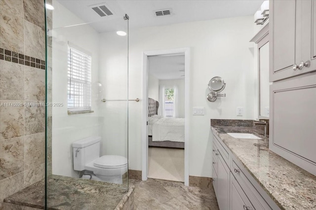 ensuite bathroom with visible vents, connected bathroom, toilet, and a walk in shower