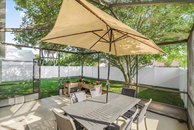 exterior space with outdoor dining space and a fenced backyard