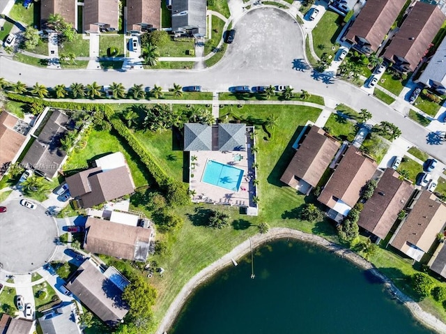 drone / aerial view with a water view and a residential view