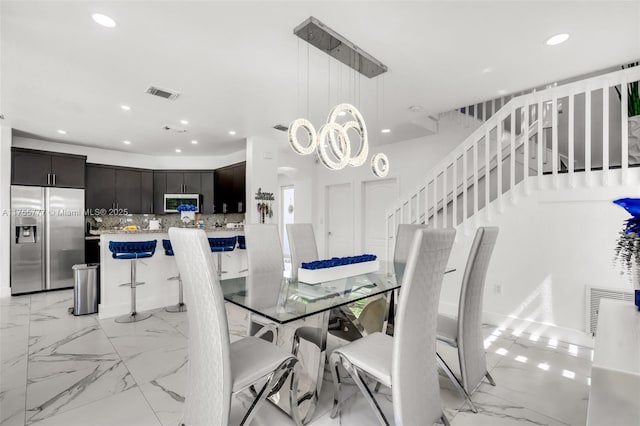 dining space featuring stairway, visible vents, marble finish floor, and recessed lighting