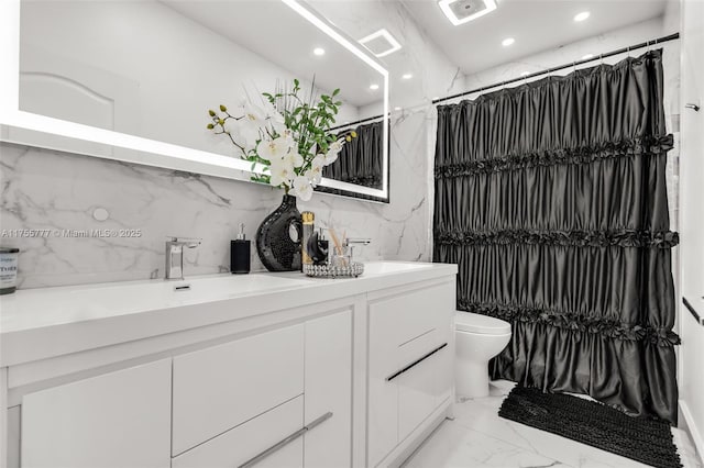 full bathroom featuring double vanity, toilet, marble finish floor, a sink, and recessed lighting