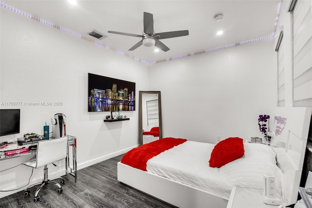 bedroom with baseboards, visible vents, ceiling fan, and wood finished floors