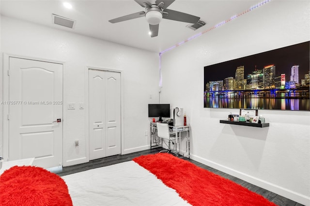 bedroom featuring visible vents, ceiling fan, baseboards, and wood finished floors