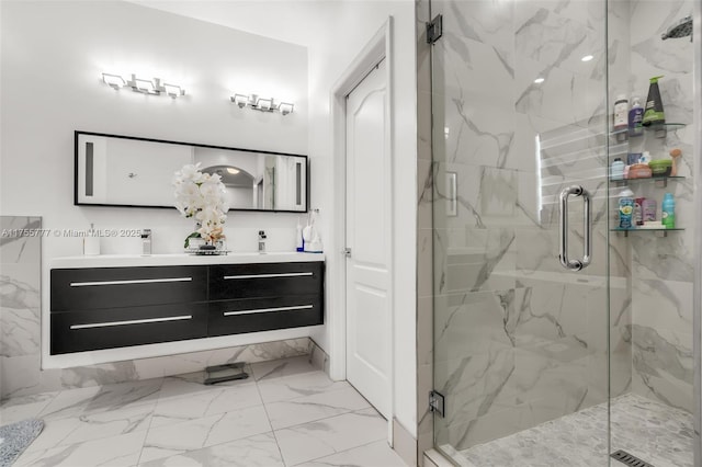 full bath featuring double vanity, marble finish floor, and a marble finish shower