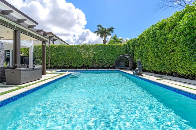 view of pool featuring a patio area, a fenced backyard, and a fenced in pool