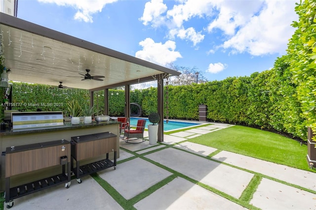 view of patio / terrace featuring ceiling fan, a jacuzzi, an outdoor pool, and grilling area