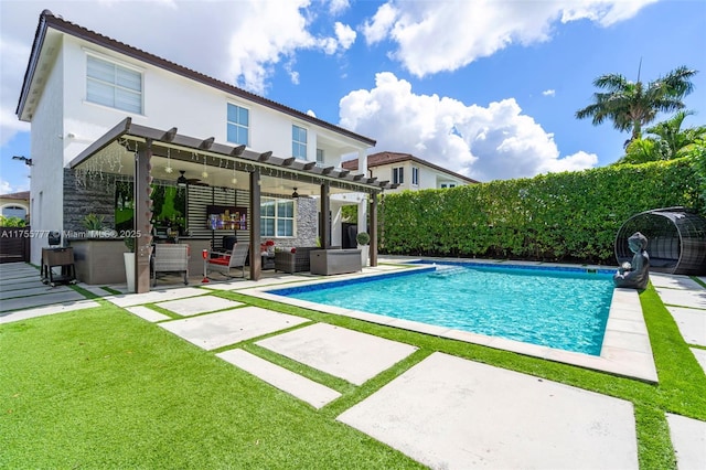 view of swimming pool featuring fence, a ceiling fan, a lawn, a fenced in pool, and a patio area