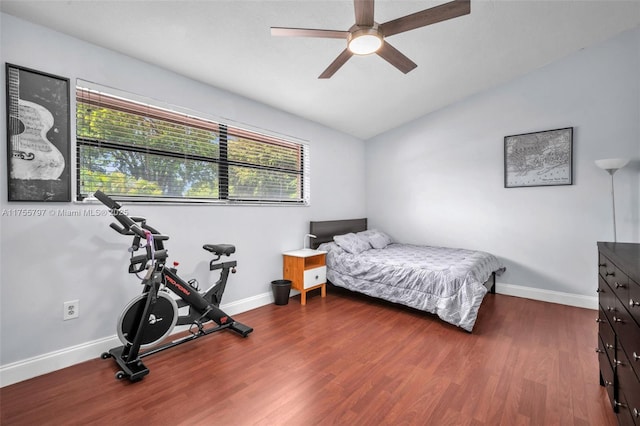 bedroom featuring lofted ceiling, ceiling fan, wood finished floors, and baseboards