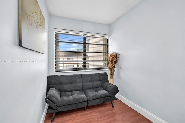 sitting room with wood finished floors and baseboards