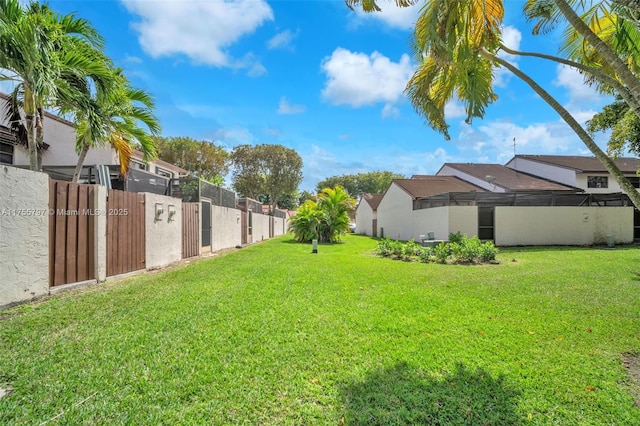 view of yard with fence and a residential view