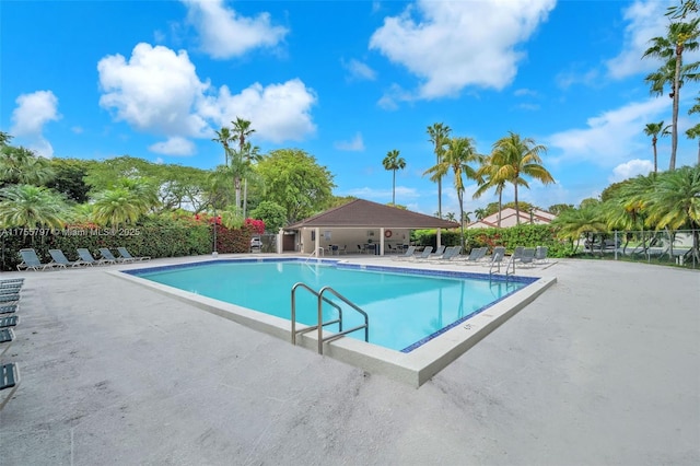 pool featuring a patio area and fence