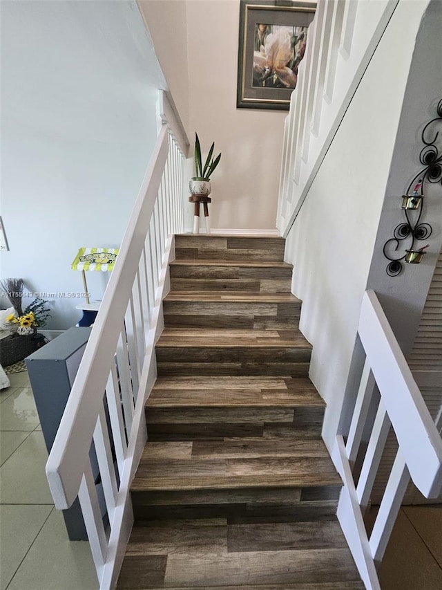 stairway featuring wood finished floors