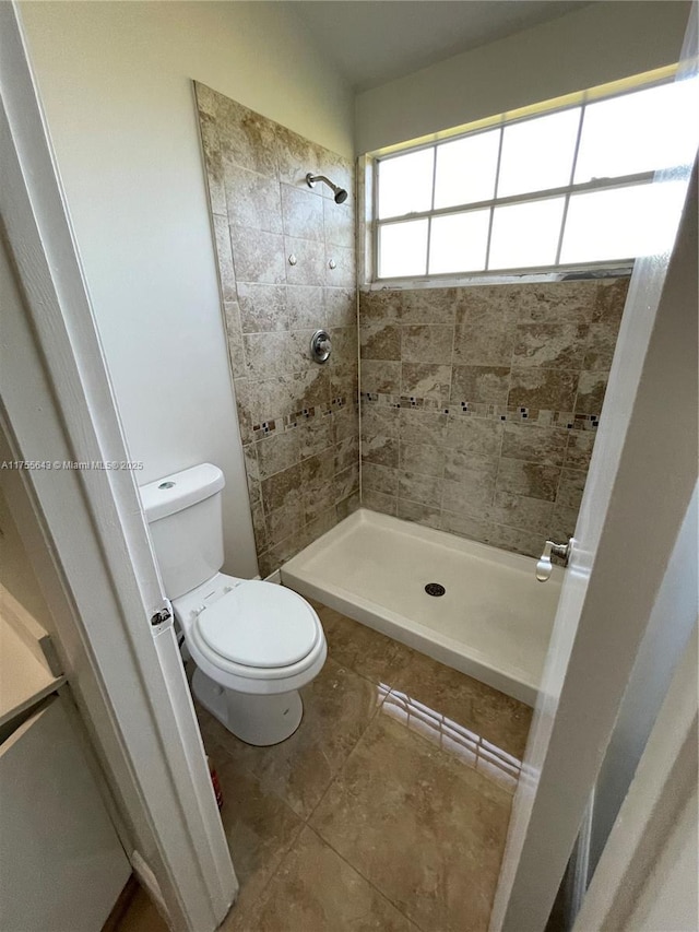 bathroom featuring a shower stall and toilet