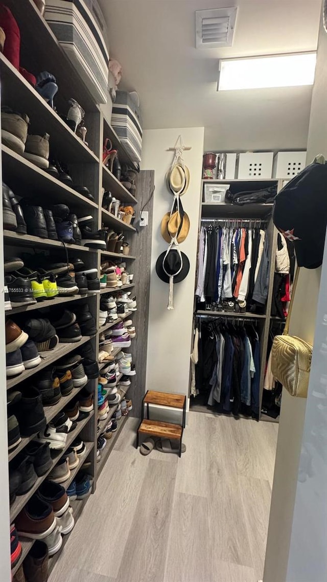 spacious closet with visible vents and wood finished floors