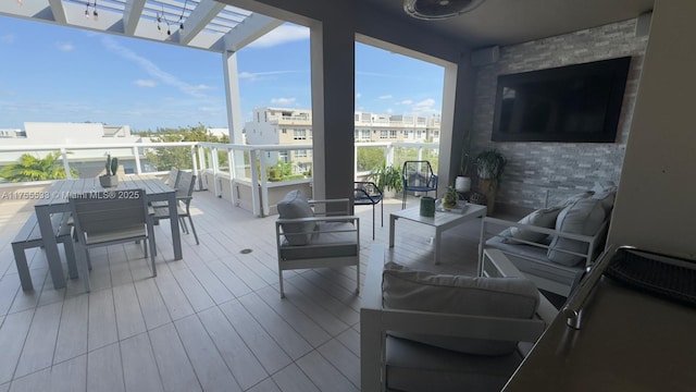 view of patio / terrace featuring a balcony, outdoor lounge area, and a pergola