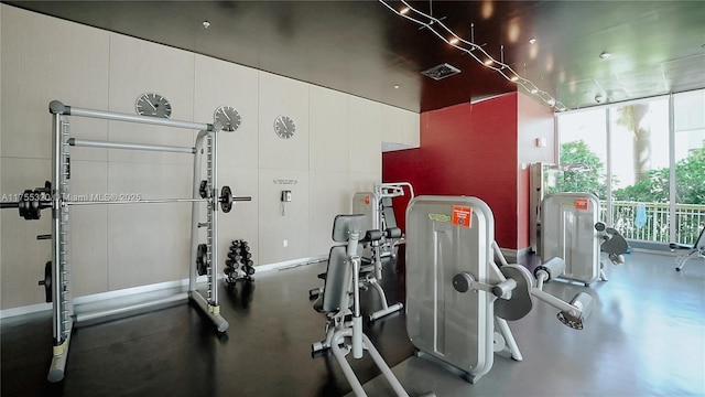 gym featuring floor to ceiling windows