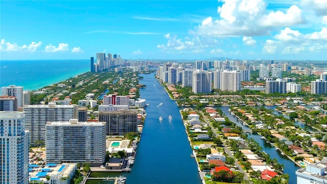 drone / aerial view featuring a view of city and a water view