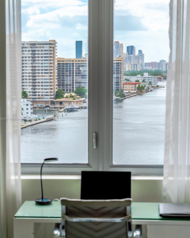 interior space with a view of city, a water view, and a healthy amount of sunlight