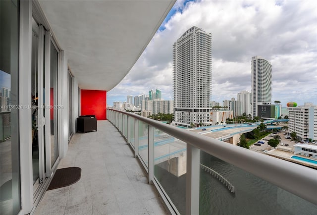 balcony with a water view and a city view