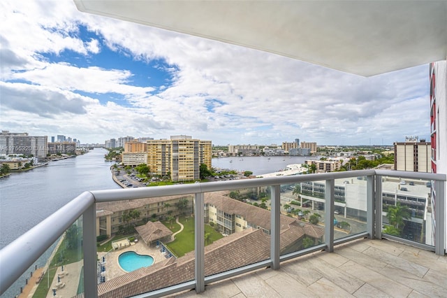 balcony featuring a water view and a city view