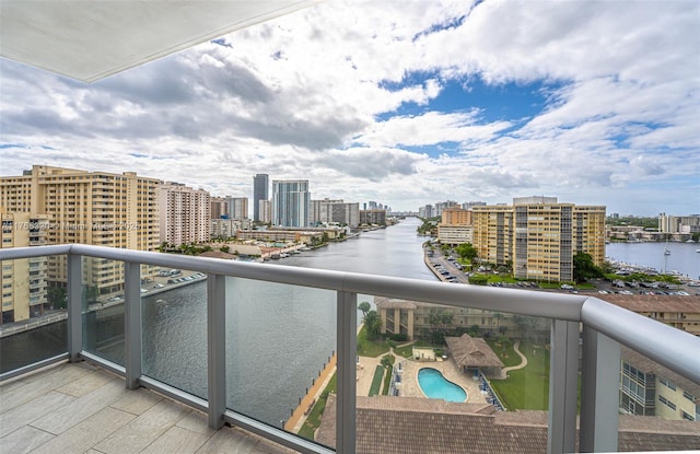 balcony featuring a view of city and a water view