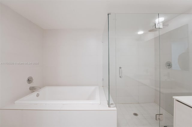 bathroom featuring a shower stall and a bath