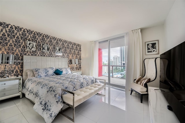 tiled bedroom featuring access to outside and floor to ceiling windows