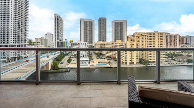 balcony featuring a water view and a view of city