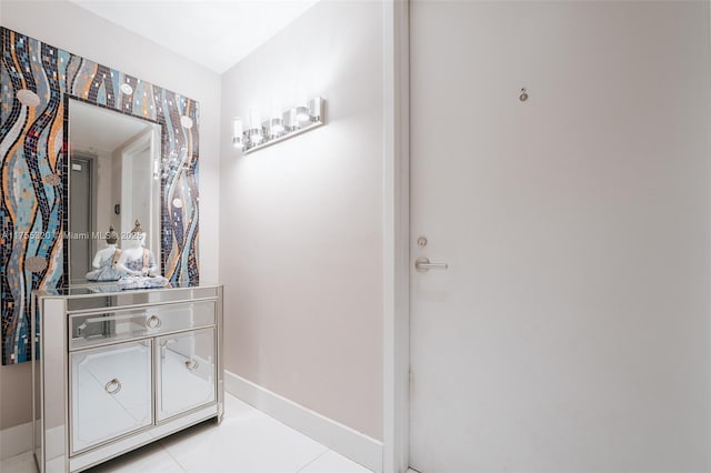 bathroom with tile patterned flooring, vanity, and baseboards