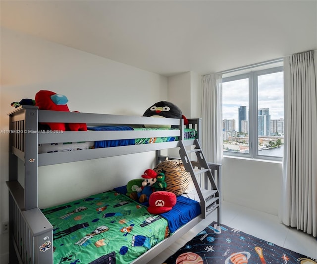 tiled bedroom with a view of city