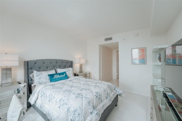 bedroom featuring light tile patterned flooring, visible vents, and baseboards