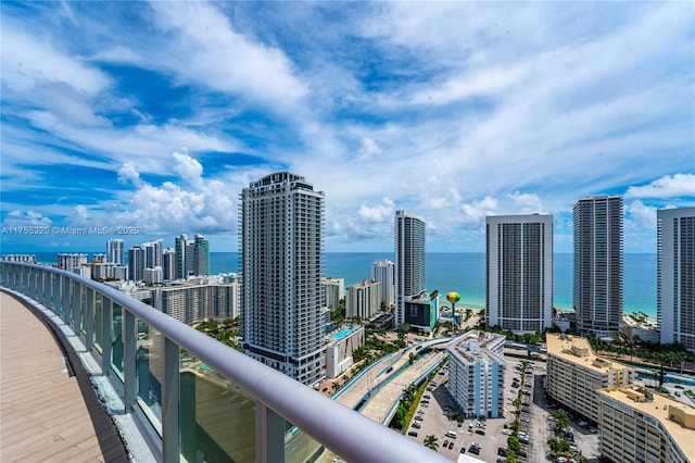 balcony with a water view, a view of city, and central AC