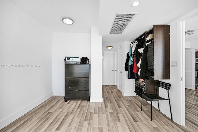walk in closet with visible vents and wood finished floors