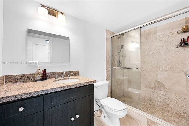 full bathroom with vanity, toilet, tile patterned floors, and a stall shower