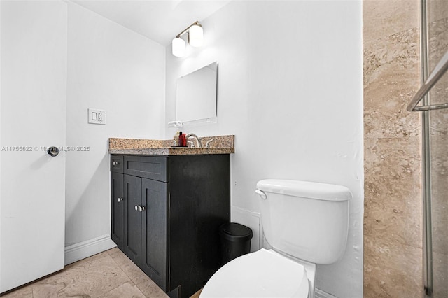 full bath with vanity, baseboards, and toilet