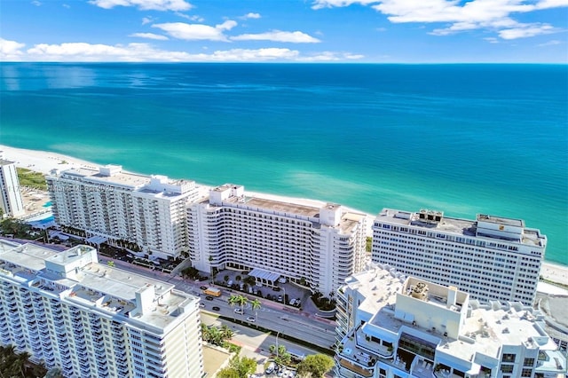 birds eye view of property featuring a beach view and a water view