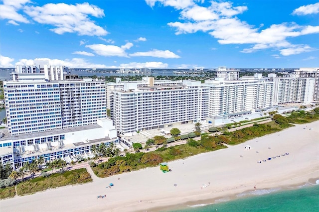 aerial view featuring a water view, a city view, and a view of the beach