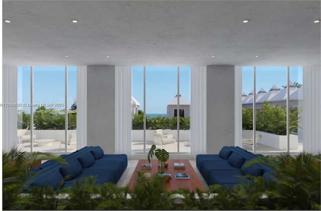 living room with recessed lighting, floor to ceiling windows, and plenty of natural light