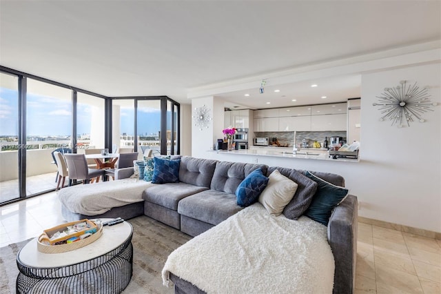 living area with light tile patterned floors, recessed lighting, and baseboards