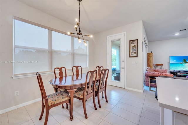 dining space with light tile patterned floors, baseboards, visible vents, and a notable chandelier