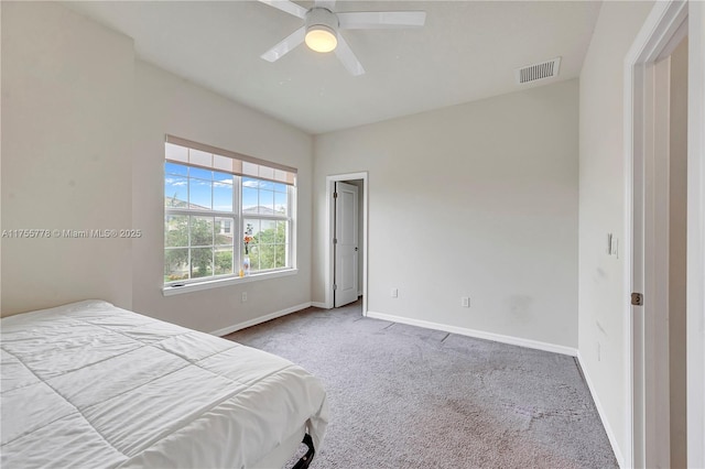 carpeted bedroom featuring ceiling fan, visible vents, and baseboards