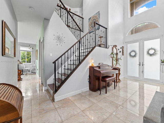 entryway featuring stairway, baseboards, and french doors