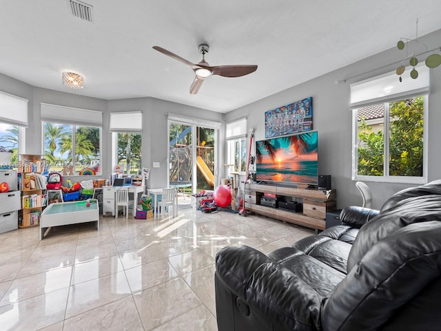 living area with marble finish floor, visible vents, and a ceiling fan