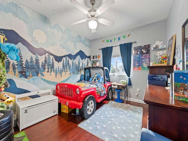 bedroom with wood finished floors, a ceiling fan, and baseboards