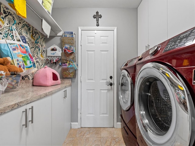 laundry room featuring cabinet space and separate washer and dryer