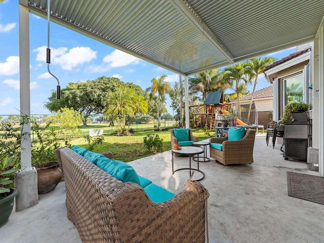 view of patio with fence, an outdoor living space, and a playground