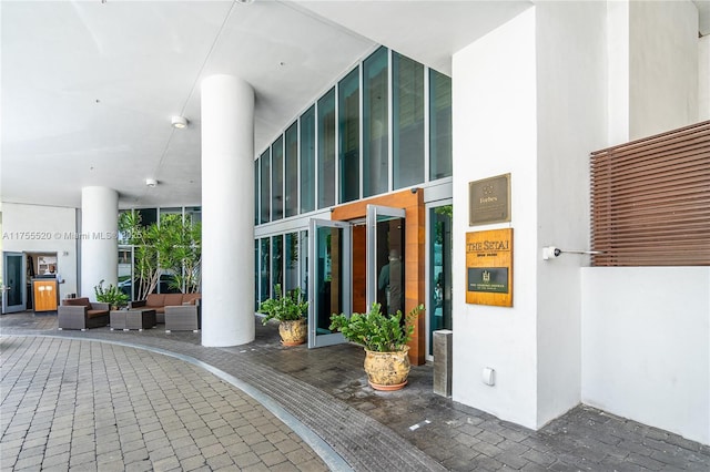 view of exterior entry with an outdoor hangout area and stucco siding