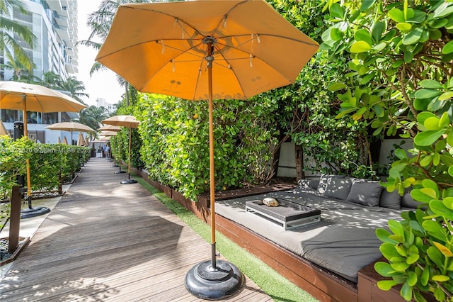 wooden terrace with an outdoor living space