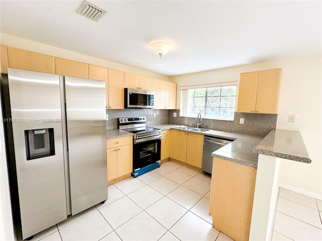 14116 SW 260th St Unit 105, Homestead, FL 33032 - kitchen with light brown cabinetry, stainless steel appliances, and a sink